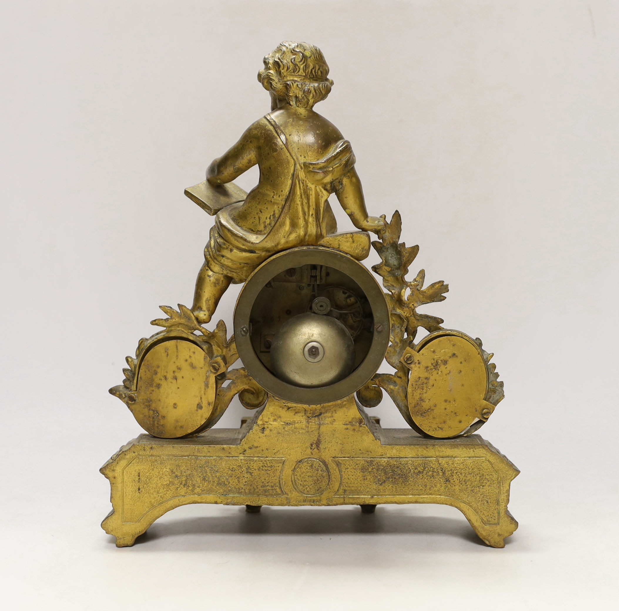 A 19th century ornate French gilt brass and porcelain clock, with two matching two branch candelabra garnitures, clock 31cm high